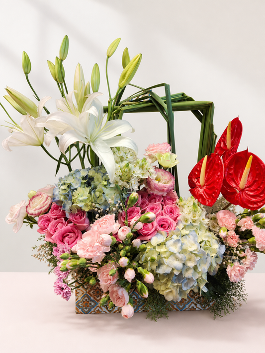 Red anthurium, blue hydrangea and white lily luxury flower basket by James Flowers Mumbai