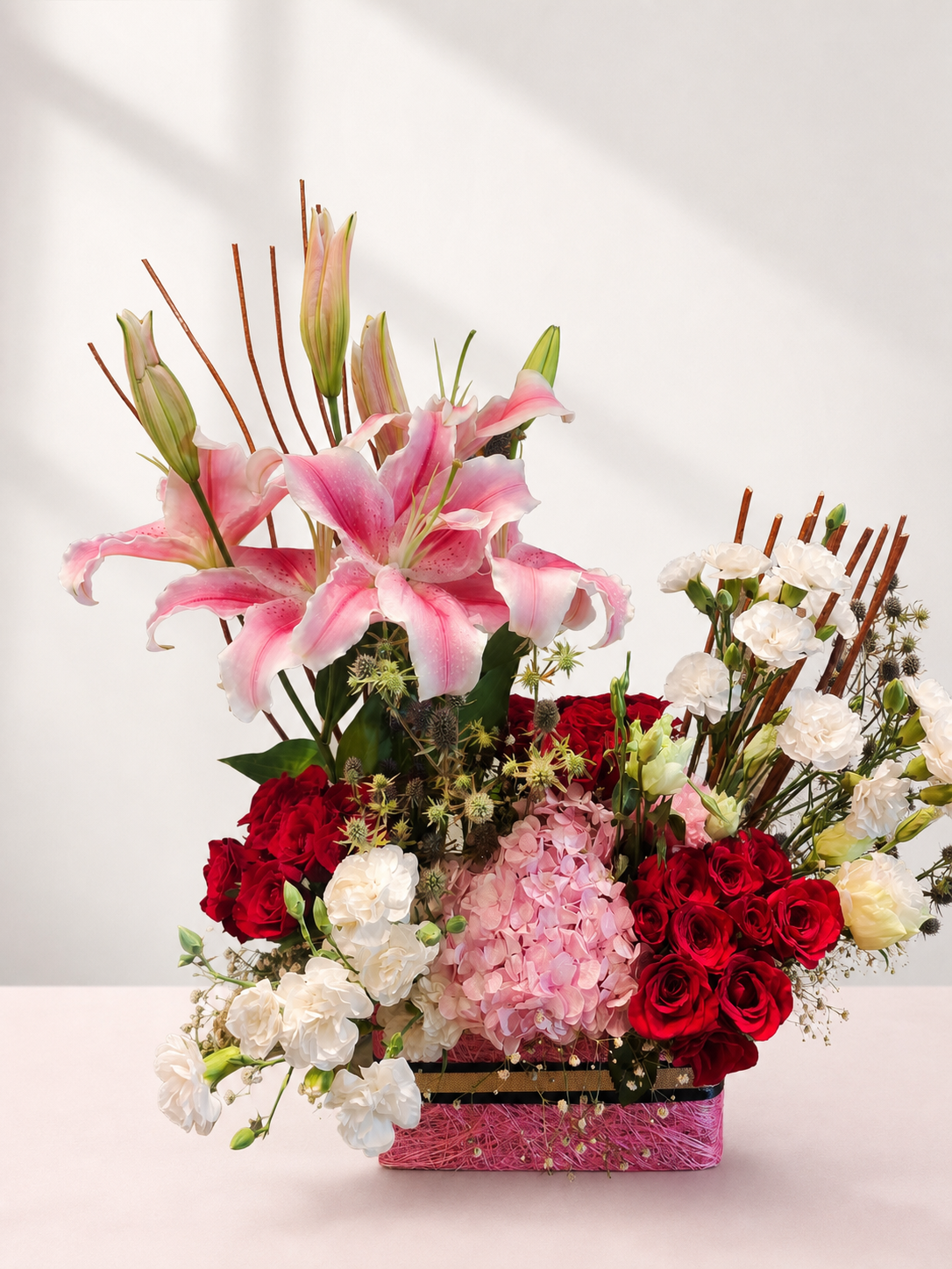 Pink lilies, red roses and hydrangeas in a luxury flower basket by James Flowers Mumbai