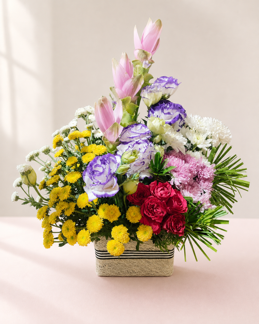 Pink lily, red rose and purple lisianthus mixed flower basket by James Flowers Mumbai