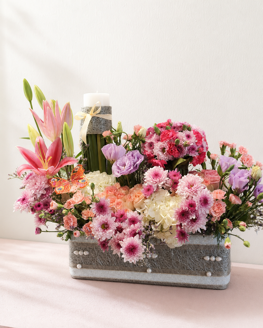 Pink lilies, peach roses and hydrangeas in a pearl flower basket by James Flowers Mumbai