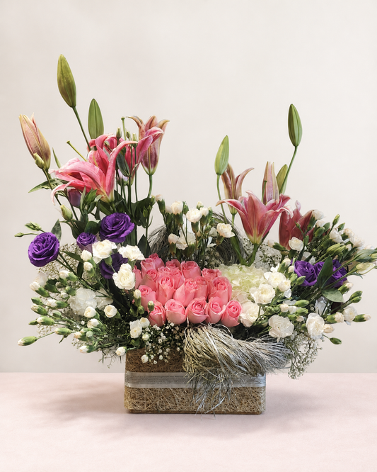Pink lilies, blush roses and purple lisianthus luxury basket by James Flowers Mumbai