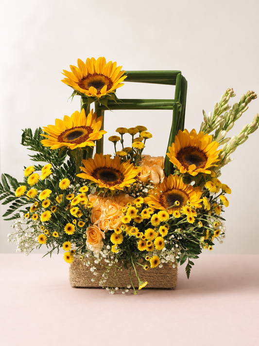 Sunflower, peach rose and yellow chrysanthemum flower basket by James Flowers Mumbai